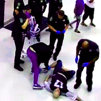 A scene from a 40-minute-long video released by the Dallas County Sheriff's Department, from a jailhouse lobby security camera, at the at Lew Sterrett Justice Center, showing Joseph Hutcheson on Aug. 1, 2015. Hutcheson entered the lobby acting erratically, was eventually subdued and handcuffed by deputies, stopped breathing, and died. - Dallas News 