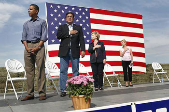 Obama, when asked about this picture said that flag pins and putting your hand over your heart had no meaning for love of country.  Really?  Then why during his campaign for president suddenly he had flags surround him on the stage, in his logo, and on his coat at every debate?  Liar, liar, pants on fire!  